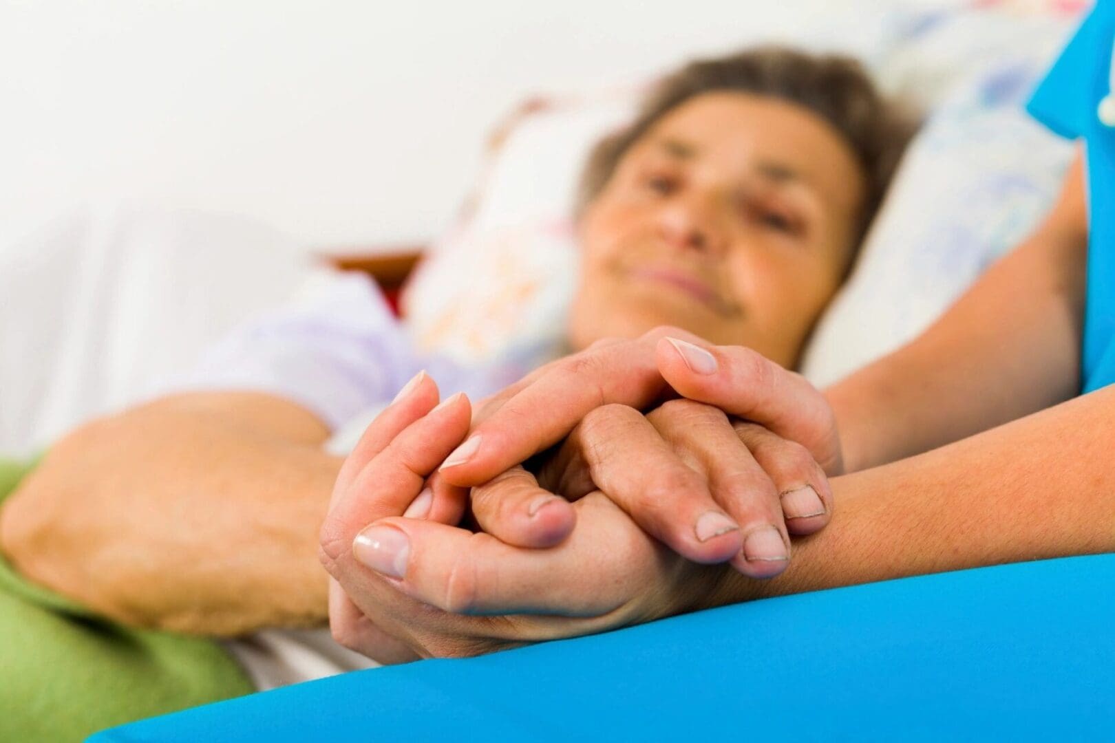 A woman holding her hands in front of another person.