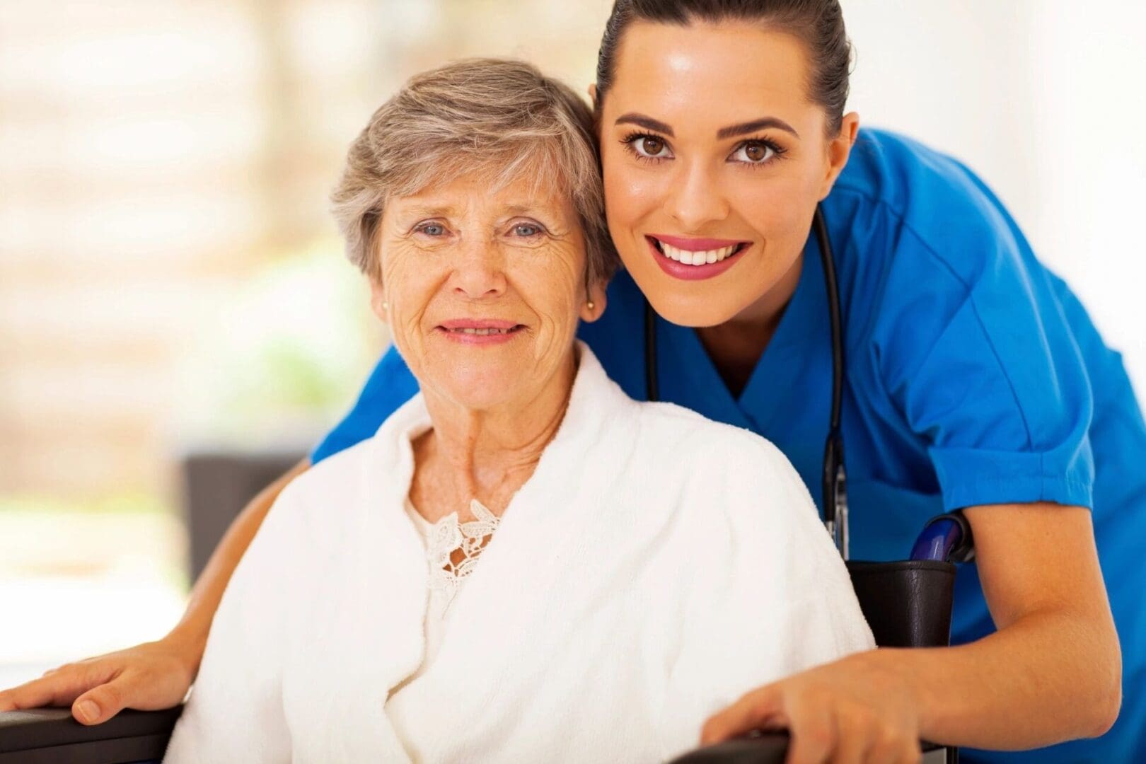 A woman and an older person smiling for the camera.